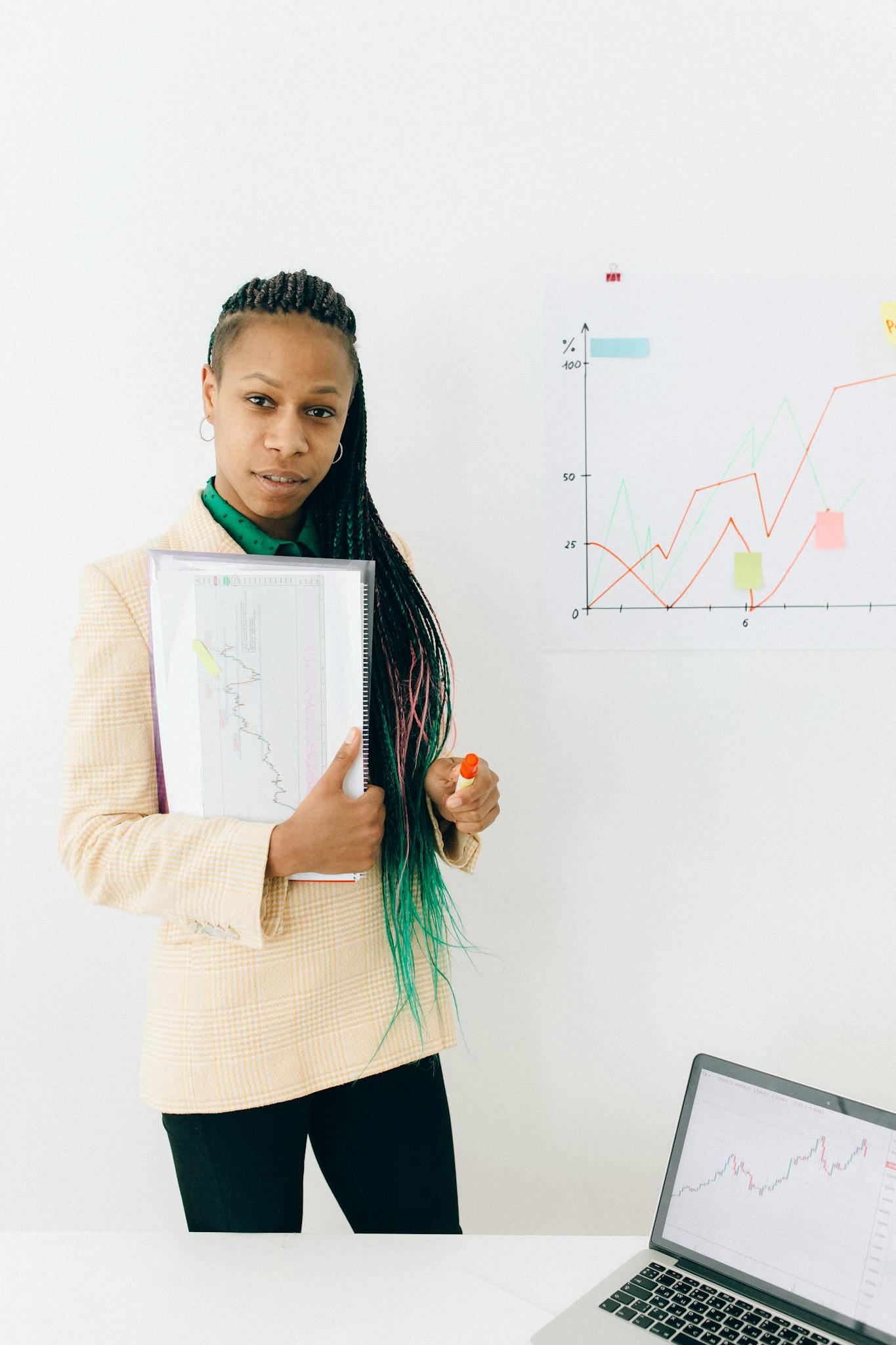 Confident analyst presenting financial data and growth charts in a modern office setting.